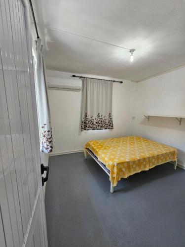 a bedroom with a yellow bed in a room at Cocotiers in Beau Champ