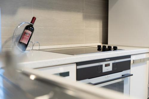 a bottle of wine sitting on a counter in a kitchen at Blue light ultracentral in Craiova