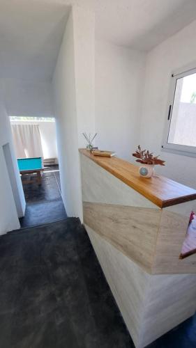 a kitchen with white walls and a wooden counter top at Aldea Mate Amargo in Potrero de Garay