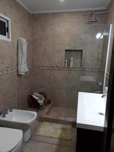 a bathroom with a shower and a sink and a toilet at De la plaza in Concordia