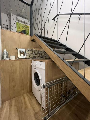 a laundry room with a washing machine and a staircase at Carbonell 1 in Valencia