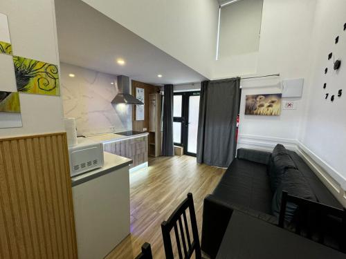 a kitchen and a living room with a couch at Carbonell 1 in Valencia