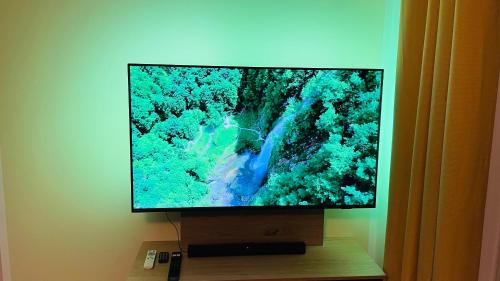 a flat screen tv sitting on top of a wooden stand at Kleine Burg Ovelgönne in Ovelgönne