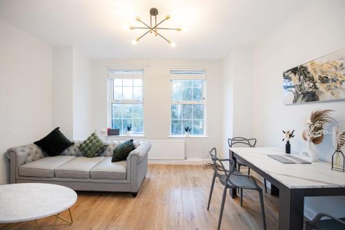 a living room with a couch and a table at Benoît Apartments in Manchester