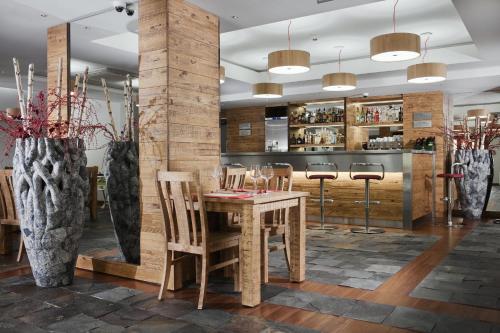 a dining room with a wooden table and chairs at Apartamenty przy Hotelu Żywieckim in Przyłęków