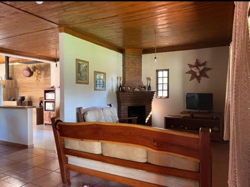 Refúgio da Mantiqueira في باسا كواترو: غرفة معيشة مع مقعد ومدفأة