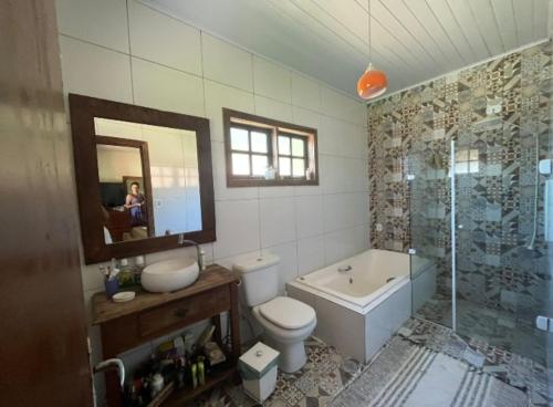 y baño con aseo, lavabo y ducha. en Refúgio da Mantiqueira en Passa Quatro