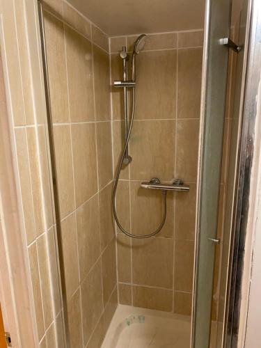 a shower with a glass door in a bathroom at River Walk Canterbury in Kent