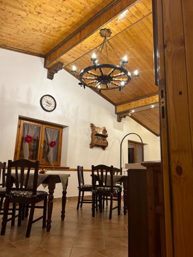 a dining room with a table and chairs and a chandelier at Il Castello in Castel di Sangro