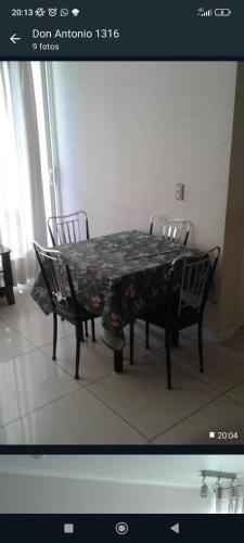 a dining room table with two chairs around it at El placer de hospedar in Santiago