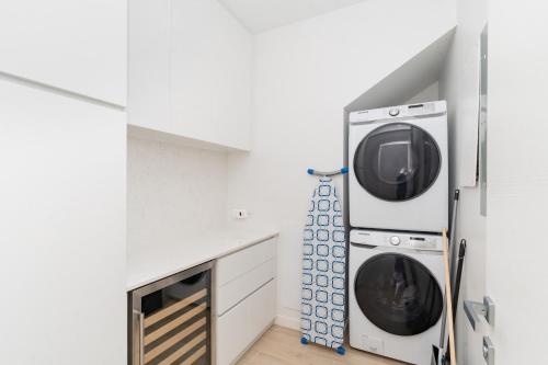 a laundry room with two washer and dryer at ONE Canal Point in Upper Land