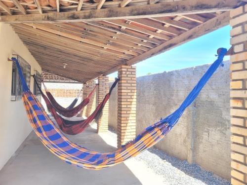 a hammock hanging from a pergola at Casa em Tibau RN. in Tibau