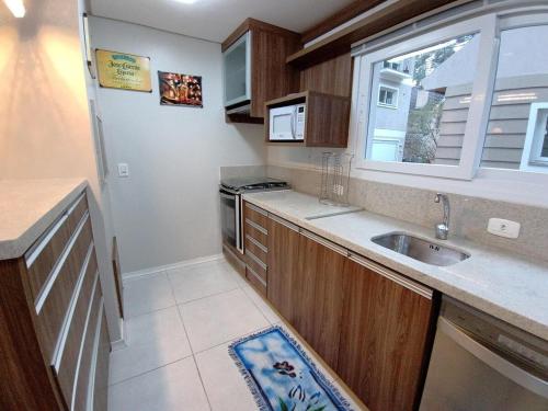 a small kitchen with a sink and a window at Casa Residencial Samira. Junto ao Centro. in Canela