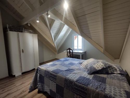 a bedroom with a bed in an attic at Casa Residencial Samira. Junto ao Centro. in Canela