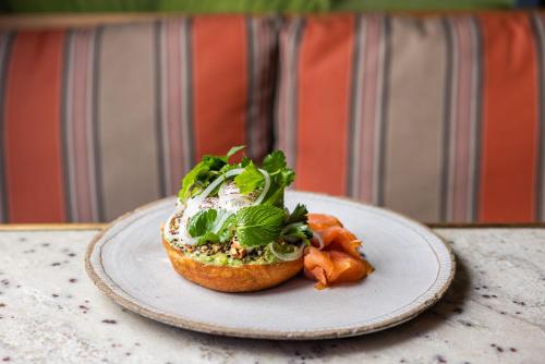 a sandwich on a plate on a table at Ovolo The Valley Brisbane in Brisbane