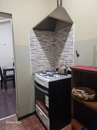 a stove in a kitchen with a brick wall at Quinta Ugarte in Ciudad Lujan de Cuyo