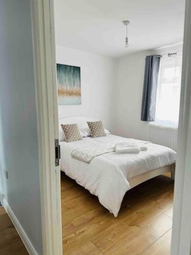 a bedroom with a bed in a white room at Milne House in Oxford