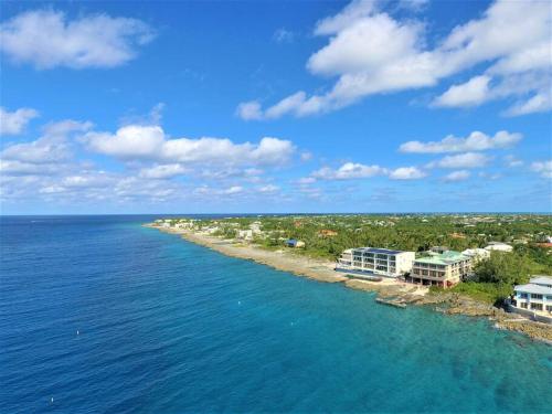 an aerial view of a beach with houses and the ocean at Lighthouse Point Resort Unit # 4 in West Bay