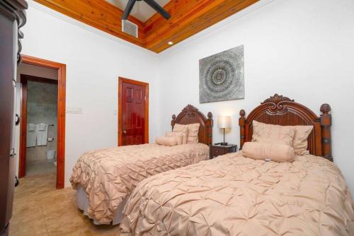 a bedroom with two beds and a bathroom at Lighthouse Point Resort Unit # 4 in West Bay