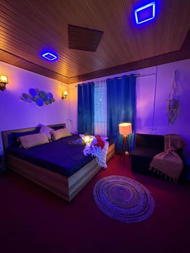 a bedroom with a bed and a purple light at Laxmi Narayan Homestay-Harshil in Harsil