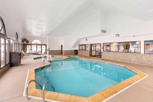 a large swimming pool with blue water in a building at Best Western St. Louis Inn in Arnold