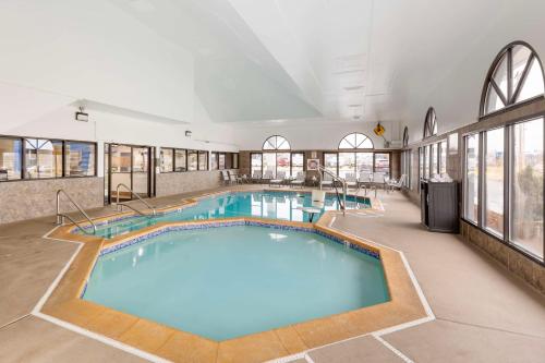 a large swimming pool in a building with windows at Best Western St. Louis Inn in Arnold