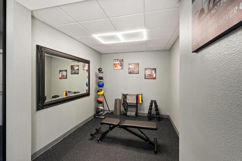 a gym with a mirror and a bench in a room at Best Western Shackleford in Little Rock