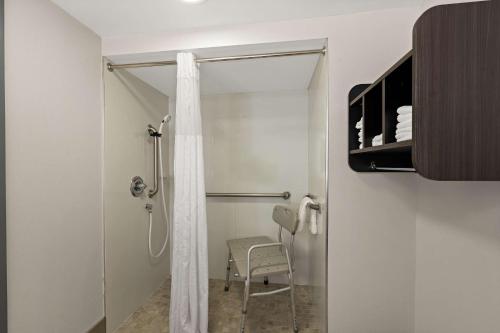 a bathroom with a shower with a shower curtain at Best Western Shackleford in Little Rock