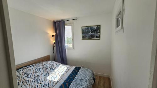 une chambre avec un lit et une fenêtre dans l'établissement Quatro Venusia, à Sète