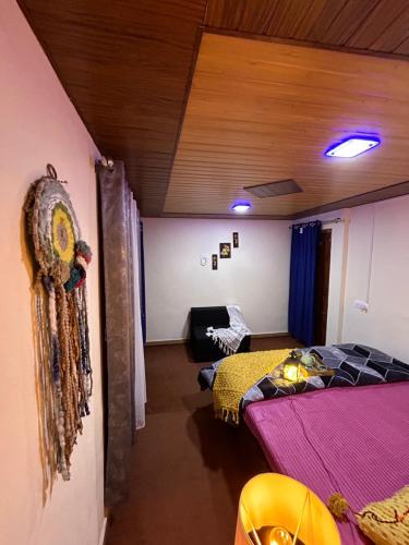 a bedroom with two beds and a ceiling at Laxmi Narayan Homestay-Harshil in Harsil