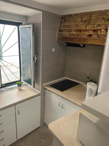a small kitchen with a sink and a window at Alfama authentic Lisbon in Lisbon