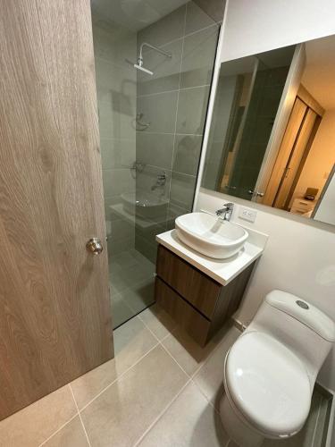 een badkamer met een toilet, een wastafel en een douche bij Apartamento en el poblado vista a todo Medellín. in Medellín