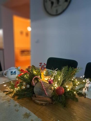 a table with a christmas centerpiece on a table at SOLEK Apartamenty i pokoje gościnne in Mielno