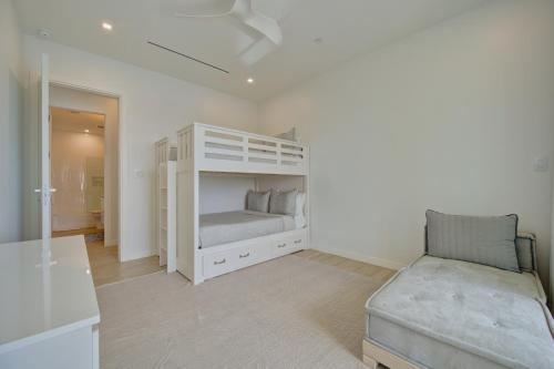 a bedroom with a white bunk bed and a chair at ONE Canal Point in Upper Land