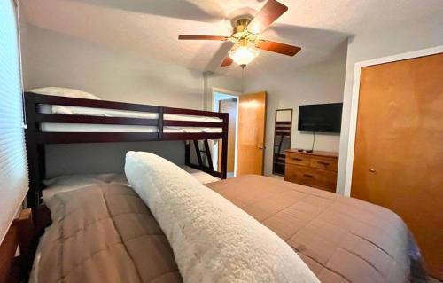 a bedroom with a bed and a ceiling fan at Lakefront Home Serene Views & Deck Near Mammoth Cave in Fentress McMahan