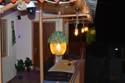 a dining room with a table and a potted plant at Laxmi Narayan Homestay-Harshil in Harsil