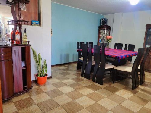 a dining room with a table and chairs in a room at Casa Cuscungo Family Experience in Quito