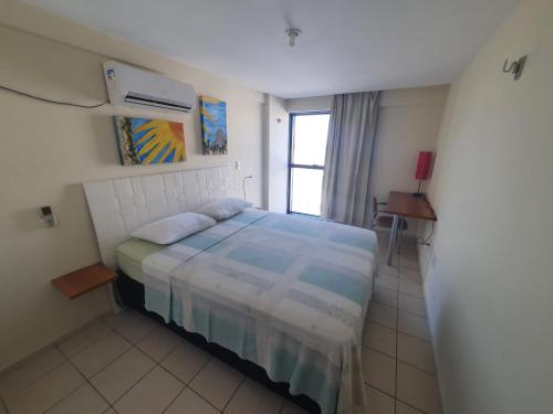 a small bedroom with a bed and a window at Apartamento 403 - Largo de Tambau in João Pessoa