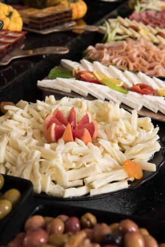 a table of food with pasta and other foods at İbos Hotels Izmir in Izmir