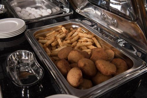 a tray of food in an oven with food in it at İbos Hotels Izmir in Izmir