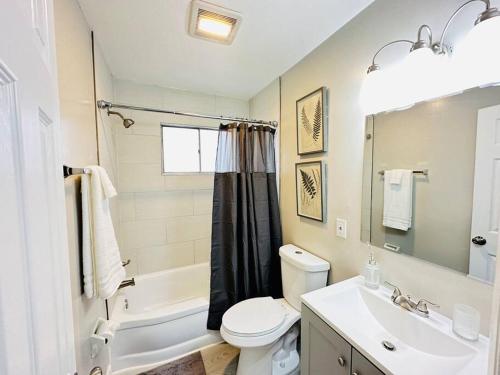 a bathroom with a sink and a toilet and a tub at Monumental Stay Near DC‘s Best! in Temple Hills