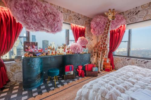 a bedroom with a bed and a giraffe in a room at Wonka Sweet Suite - New York in New York
