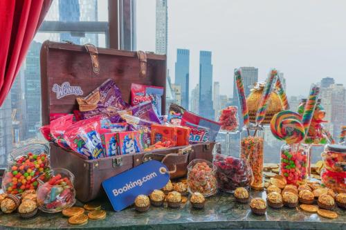 a table with a bunch of candy and other snacks at Wonka Sweet Suite - New York in New York