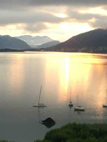 a group of boats in a large body of water at Appartement mit Seeblick am Ossiacher See in Villach