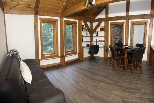 a living room with a couch and a table at Panoramic Mountain views w/hot tub, hiking trail in Fairlee