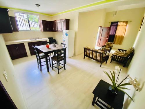 a kitchen and dining room with a table and chairs at Le Bigot Appartements in Marotte