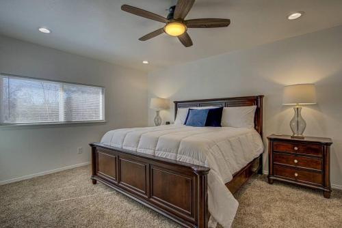 a bedroom with a bed and a ceiling fan at Entire Cozy Getaway with Pool in Norman