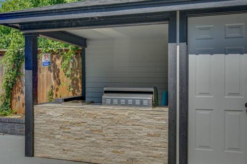 a garage with a white door next to a house at Entire Cozy Getaway with Pool in Norman