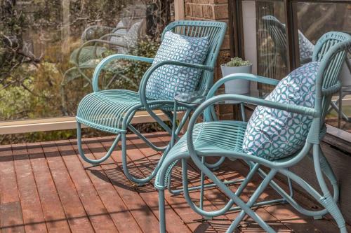 a group of chairs sitting on a porch at Seaglass at Pambula Beach in Pambula Beach