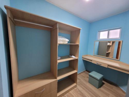 a dressing room with wooden shelves and a window at 321 Surprise Beach house and Glamping in Providencia
